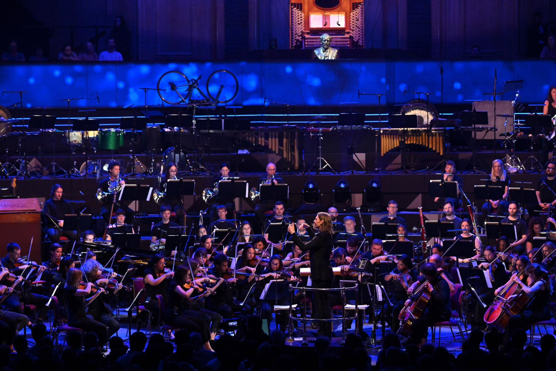 Robert Ames conducting the orchestra on stage